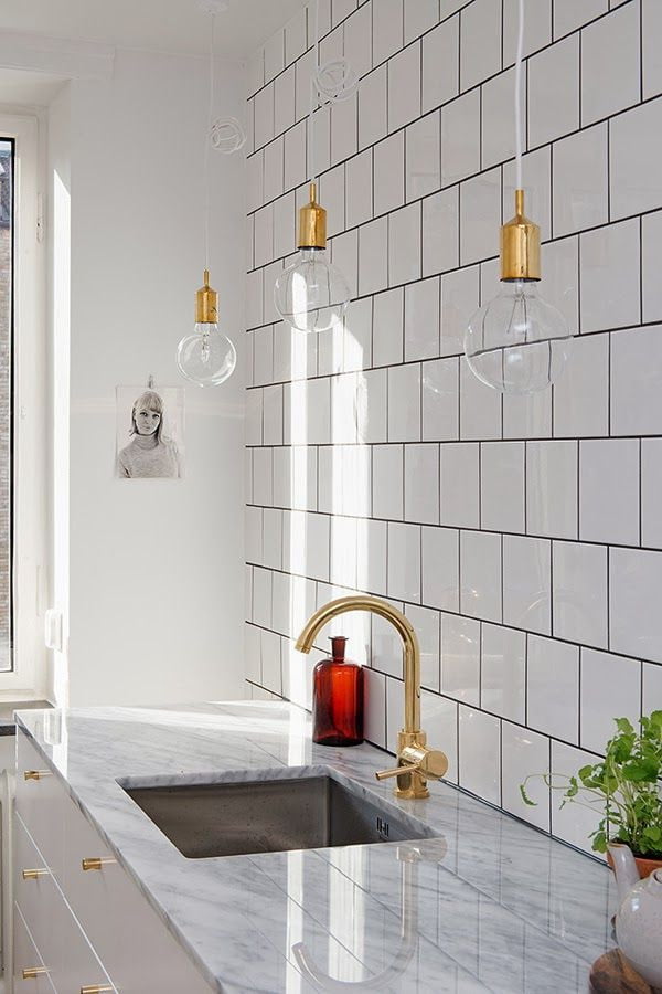 A beautiful combination of square tiles and accents lighting with gold accents