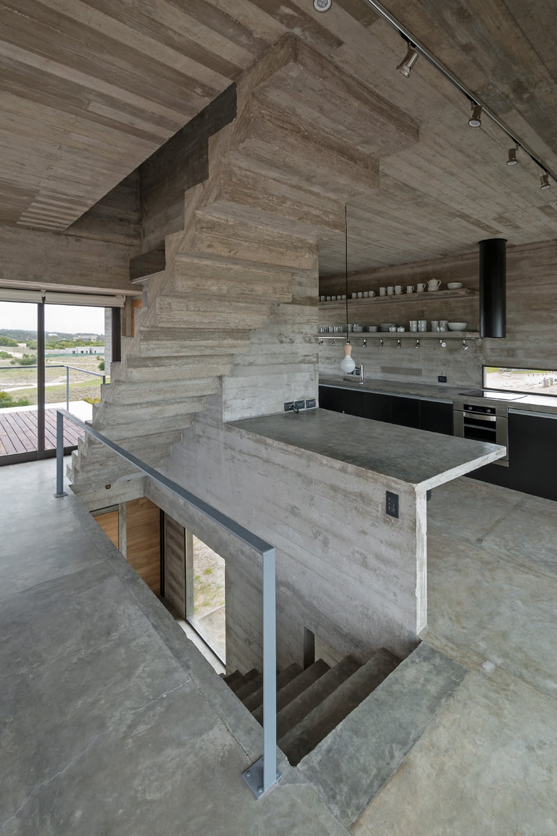 exposed concrete modern house and wooden furniture