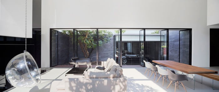 Living and dining area lit with light drawn from internal courtyard space