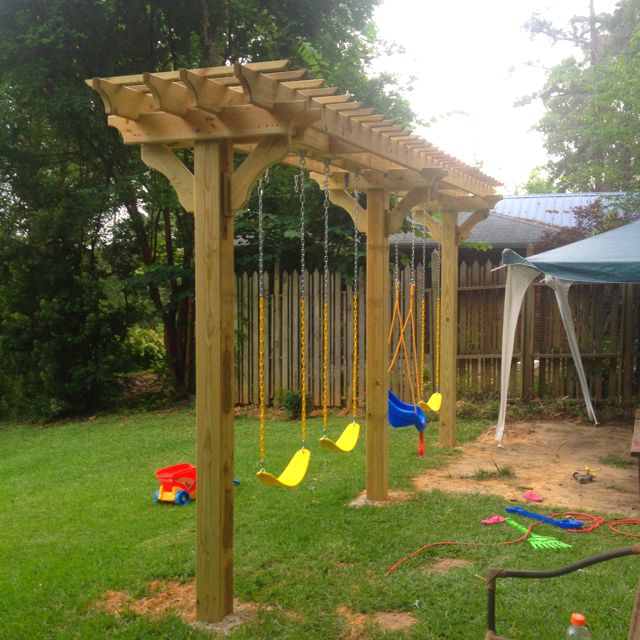 Swing set in backyard pergola