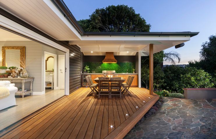 Floating outdoor deck design with covered patio in backyard of modern house