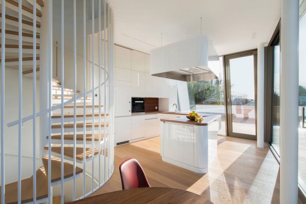 Steel spiral stair with wooden steps in modern house