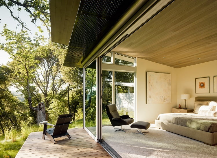 Deck area with Sloped ceilings, covered with stained Western red cedar, add warmth to the interior