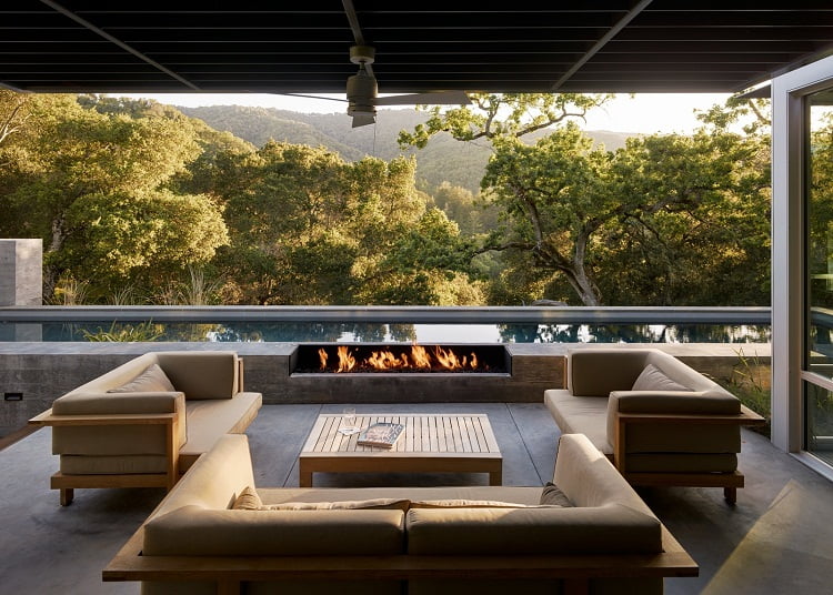 the residents stream music from their phones in outdoor room of ranch house