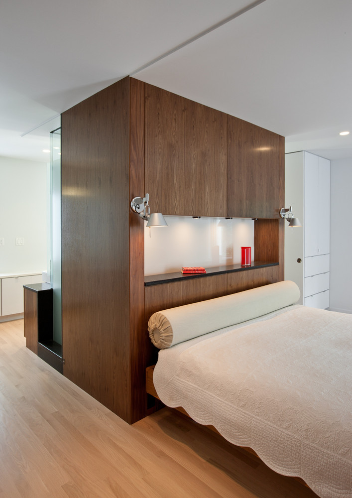 bedroom photo, wooden finish back drop, bath behind bed, wooden flooring, white ceiling, sunken bed head, full length pillow,