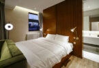 bath behind bed area, bath mirror, white counter basin,