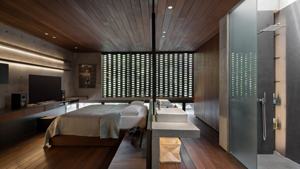 bath behind bed head, white bed, counter basin, wooden flooring, wooden ceiling, interior photography,